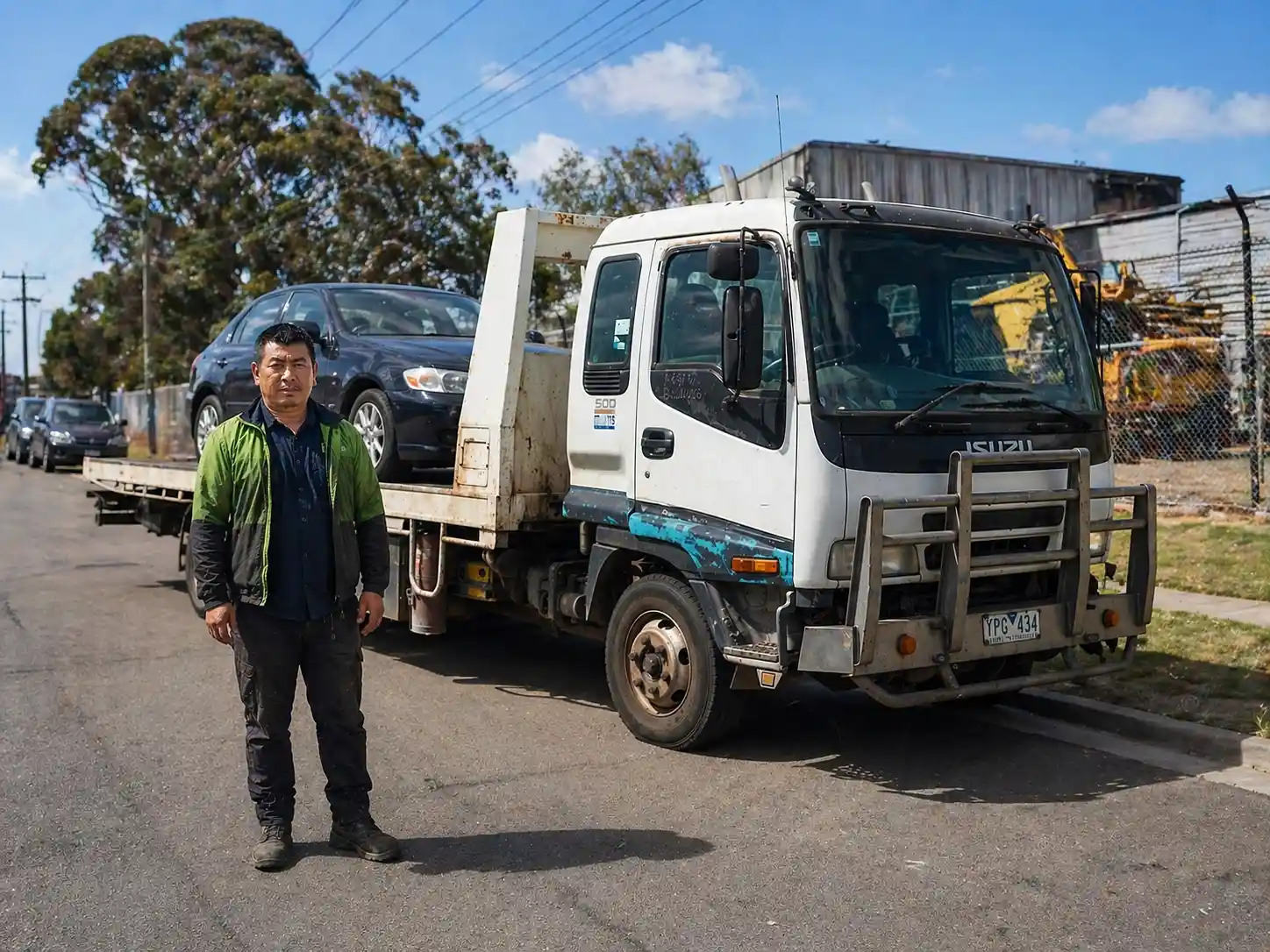 Amiry Cash For Cars tow truck operator loading a scrap car from a tight residential driveway in Point Cook