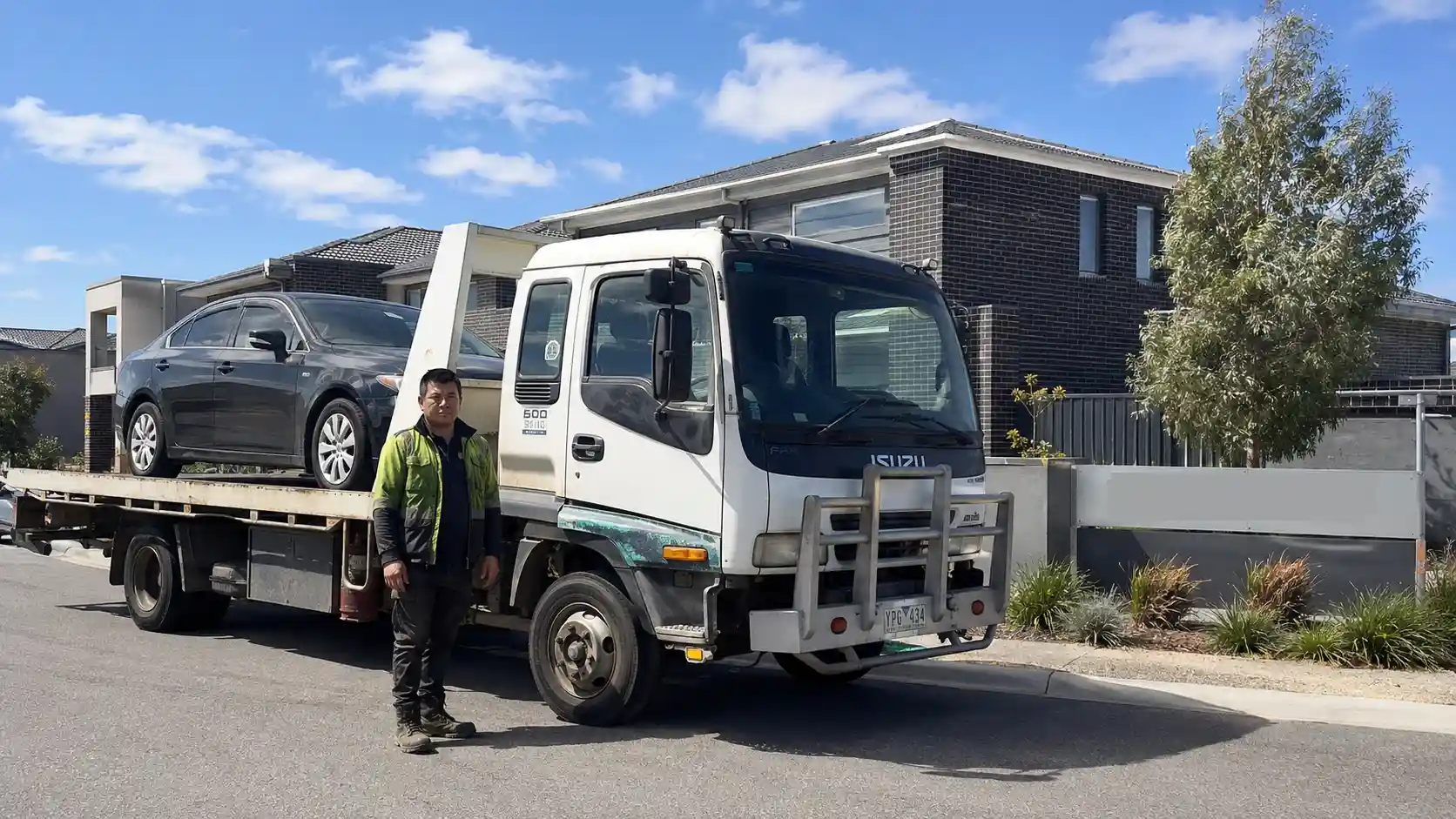 Amiry Cash For Cars tow truck driver loading a rusted ute from a backyard in Wyndham Vale